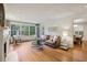 Sunlit living room with hardwood floors, fireplace, and large windows at 521 E Wesley Ne Rd, Atlanta, GA 30305