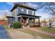 Two-story house with gray siding, a wraparound porch, and a brick walkway at 679 N Central Ave, Hapeville, GA 30354