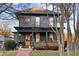 Two-story house featuring a gray exterior, wraparound porch, and landscaped yard at 679 N Central Ave, Hapeville, GA 30354