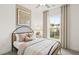 Charming bedroom with a metal bed frame and large window at 106 Delilah St, Mcdonough, GA 30252