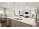 Open kitchen layout with a large island and views into the living room at 106 Delilah St, Mcdonough, GA 30252