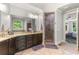 Large bathroom with double vanity, shower, and access to bedroom at 1185 Weldstone Ct, Atlanta, GA 30350