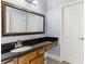 Bathroom with dark vanity and a large mirror at 1185 Weldstone Ct, Atlanta, GA 30350