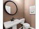 Powder room with pedestal sink, updated toilet, and modern decor at 2620 Ravencliff Dr # 163, Austell, GA 30168