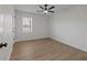 Well-lit bedroom with ceiling fan and hardwood floor at 350 Meadow Trace, Auburn, GA 30011