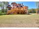 Beautiful backyard featuring a deck with stairs, a well-maintained lawn, and a brick home at 43 Iroquois Ct, Covington, GA 30014
