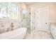 Bathroom with soaking tub, glass enclosed shower and window at 43 Iroquois Ct, Covington, GA 30014