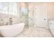 Bathroom with soaking tub, glass enclosed shower and bright window at 43 Iroquois Ct, Covington, GA 30014