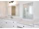 Bathroom features double vanities, lighted mirrors and modern finishes at 43 Iroquois Ct, Covington, GA 30014