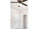 Bright bedroom featuring a modern ceiling fan, white trim, and access to another room through a connecting door at 43 Iroquois Ct, Covington, GA 30014
