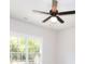 Well-lit bedroom showcasing a modern ceiling fan and a large window allowing for plenty of natural light at 43 Iroquois Ct, Covington, GA 30014
