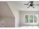 Bonus room featuring a bright window overlooking a wooded area, and a ceiling fan at 43 Iroquois Ct, Covington, GA 30014