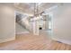 Elegant dining room with modern light fixture and an open view to the staircase at 43 Iroquois Ct, Covington, GA 30014