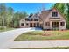 Gorgeous two-story brick home featuring a lush lawn, long driveway, and a three-car garage at 43 Iroquois Ct, Covington, GA 30014