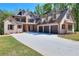 Stately brick home with a three-car garage, lush lawn, and inviting front porch at 43 Iroquois Ct, Covington, GA 30014