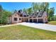 Elegant brick home with a three-car garage, a large driveway, and a neatly landscaped yard at 43 Iroquois Ct, Covington, GA 30014