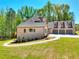 Beautiful two-story brick home featuring a three-car garage, well-manicured lawn and a long driveway at 43 Iroquois Ct, Covington, GA 30014