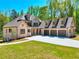 Beautiful two-story brick home featuring a three-car garage, well-manicured lawn and a long driveway at 43 Iroquois Ct, Covington, GA 30014
