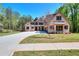 Beautiful brick home with a well-manicured lawn and long driveway leading to a three car garage at 43 Iroquois Ct, Covington, GA 30014