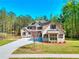Charming two-story brick home with manicured front yard and long driveway leading to the front entrance at 43 Iroquois Ct, Covington, GA 30014
