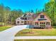 Charming two-story brick home with manicured front yard and long driveway leading to the front entrance at 43 Iroquois Ct, Covington, GA 30014