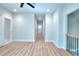 Modern hallway showcasing hardwood flooring and elegant iron and wood railings offering a blend of style and functionality at 43 Iroquois Ct, Covington, GA 30014