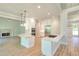 Modern kitchen boasts white cabinetry, stainless steel appliances, double islands and wood floors at 43 Iroquois Ct, Covington, GA 30014