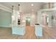 A modern kitchen featuring white cabinetry, stainless steel appliances, double islands, and hardwood floors at 43 Iroquois Ct, Covington, GA 30014