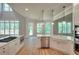 Bright kitchen with white cabinets, quartz countertops, stainless steel appliances, and natural light at 43 Iroquois Ct, Covington, GA 30014