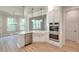 Updated kitchen featuring stainless steel appliances, farmhouse sink, white cabinets, and hardwood flooring at 43 Iroquois Ct, Covington, GA 30014