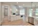 Modern kitchen with stainless steel appliances, white cabinetry, quartz countertops, and hardwood flooring at 43 Iroquois Ct, Covington, GA 30014