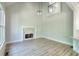 Spacious living room featuring stone fireplace, light wood floors, and large window bringing in plenty of light at 43 Iroquois Ct, Covington, GA 30014