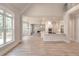 Bright, open-concept living space with hardwood floors, connecting kitchen, dining area, and living room at 43 Iroquois Ct, Covington, GA 30014