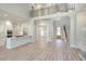 Spacious open-concept living room features wood floors, a staircase, a stone fireplace, and modern kitchen at 43 Iroquois Ct, Covington, GA 30014