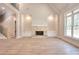 Bright living room with a stone fireplace, recessed lighting, and large windows offering serene views at 43 Iroquois Ct, Covington, GA 30014