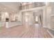 Spacious open-concept living space with kitchen, dining area, and staircase, all featuring hardwood floors at 43 Iroquois Ct, Covington, GA 30014