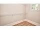 Walk-in closet with laminate floor, white trim and closet organizer shelving at 43 Iroquois Ct, Covington, GA 30014