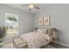 Bedroom with floral bedding, ceiling fan, and neutral wall decor at 121 Aj Welch Jr Way, Mcdonough, GA 30252