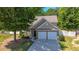 Two-story house with two-car garage and mature landscaping at 2401 Centennial Hill Nw Way, Acworth, GA 30102