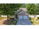 House exterior with two-car garage and landscaped yard at 2401 Centennial Hill Nw Way, Acworth, GA 30102