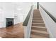 Elegant staircase leading to upper level with view of living room and fireplace at 2401 Centennial Hill Nw Way, Acworth, GA 30102