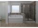 Bathroom with soaking tub, walk-in shower, and tile flooring at 325 Allgood Trce, Acworth, GA 30101