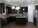 Modern kitchen with dark cabinetry and granite island at 325 Allgood Trce, Acworth, GA 30101