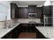 Modern kitchen with dark cabinetry and granite island at 325 Allgood Trce, Acworth, GA 30101