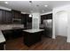 Modern kitchen with dark cabinetry and granite island at 325 Allgood Trce, Acworth, GA 30101