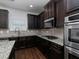 Modern kitchen with dark cabinetry and granite island at 325 Allgood Trce, Acworth, GA 30101