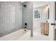 Bathroom with gray tile, a freestanding tub, and a floating vanity at 5603 Owens Dr, Austell, GA 30106