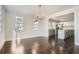 Open concept dining room with kitchen view and hardwood floors at 5603 Owens Dr, Austell, GA 30106