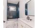 Spa-like bathroom with blue tile shower and white vanity at 89 1St Ne Ave, Atlanta, GA 30317