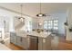 Open kitchen with an island, stainless steel appliances and hardwood floors at 89 1St Ne Ave, Atlanta, GA 30317